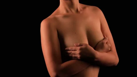 Woman covering her naked breasts - Stock Image - F006/4245