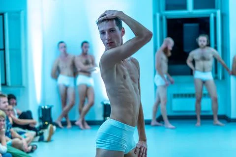 Naked freestyle dancers performing in an indoor setting Stock Photos
