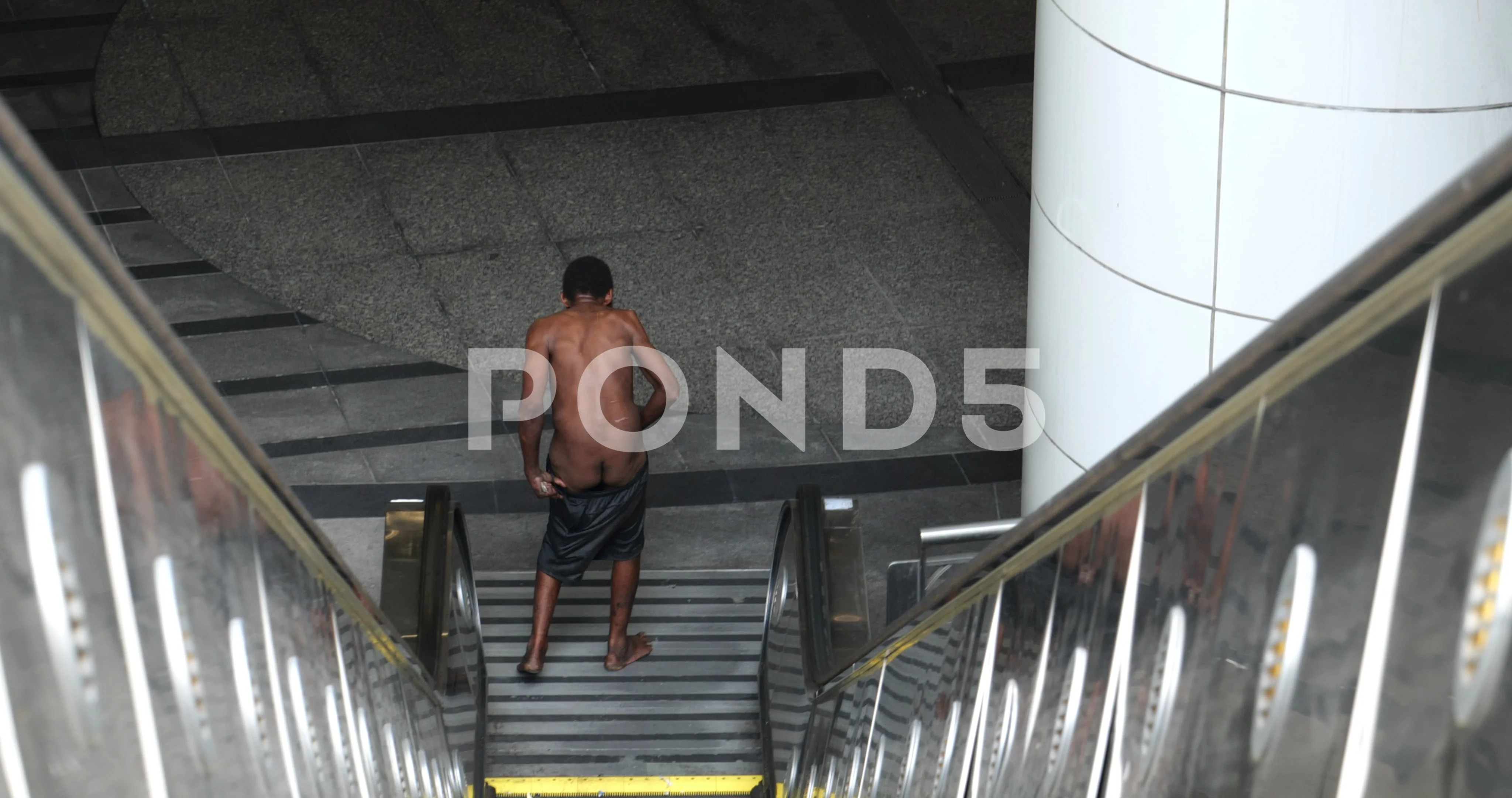 A naked homeless man on the escalator to... | Stock Video | Pond5