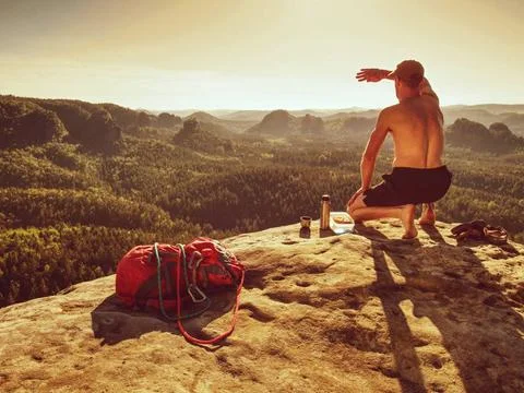 Naked man having picnic. Toples climber sit and eat sandwich Naked sportsm... Stock Photos