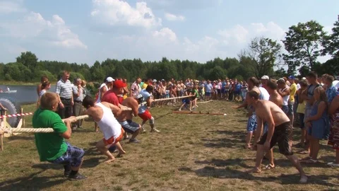Naked men pull the rope.Traditional holiday entertainment in Belarus.Belarus/Osh Stock Footage 127557820