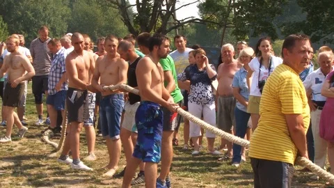 Naked men pull the rope.Traditional holiday entertainment in Belarus.Belarus/Osh Stock Footage 127557933