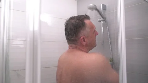 Naked middle-aged man taking a hot shower Video stock 93935523