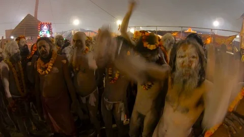 Naked naga baba smeared with ashes with flower garlands raise hands up glorify g Stock Footage 106443279