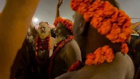 Naked naga baba smeared with ashes with flower garlands shout Har Har Mahadev hu Stock Footage 106443315