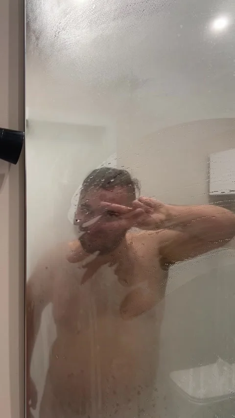 Naked white man with beard dancing in hotel bath room near mirror Stock Footage 304361578