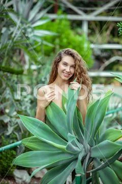 Naked Woman Standing Near The Plant And Smiling Hi Res