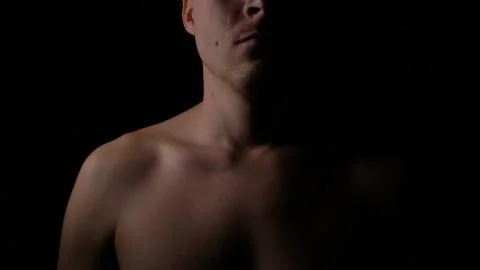 Nakked man posing in studio. Short haired model man with muscular body looking Stock Photos