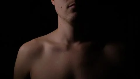 Nakked man posing in studio. Short haired model man with muscular body looking Stock Photos