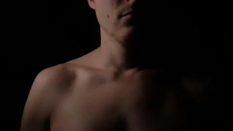 Nakked man posing in studio. Short haired model man with muscular body looking Stock Photos