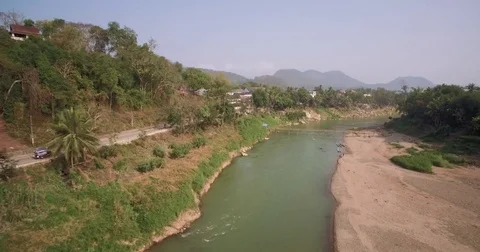 Nam Khan River Next To Ancient City Of Luang Prabang, Laos, Ascending Pullback Stock Footage 79379558