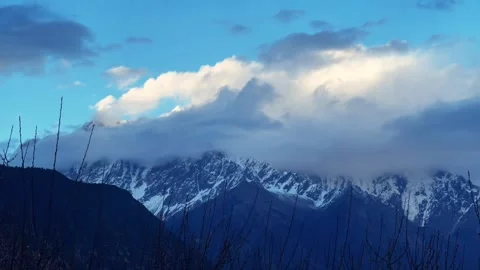 Namcha Barwa Peak covered by clouds, time - lapse photography Stock Footage 312557548