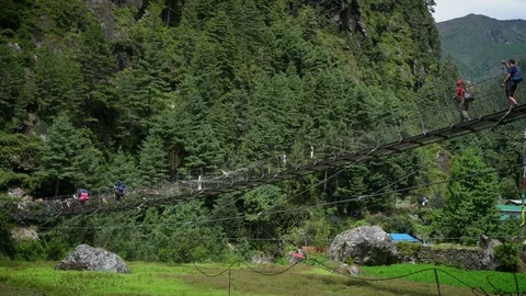NAMCHE BAZAAR, NEPAL - 12 SEPTEMBER 2017 : Trekkers Crossing Hanging Bridge , Stock Footage 84935719