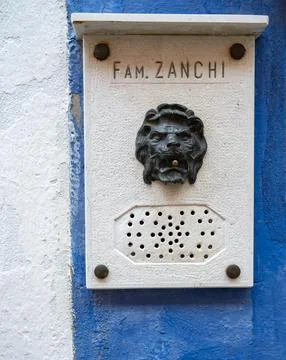 Name and doorbell button in the shape of a lion on a blue house wall, Burano Stock Photos