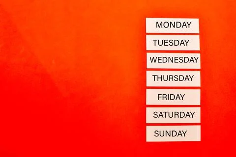 Name of seven days in memo notes on red background with copy space Stock Photos