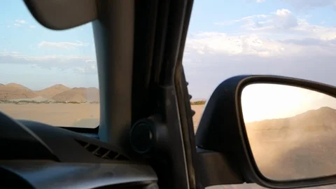 Namibia camera car, dry landscape, Africa HD cloudy, sunset in rearview mirror Stock Footage 90887074