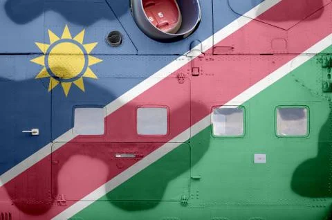 Namibia flag depicted on side part of military armored helicopter closeup. Ar Stock Photos