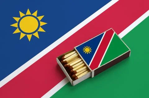 Namibia flag  is shown in an open matchbox, which is filled with matches and  Stock Photos