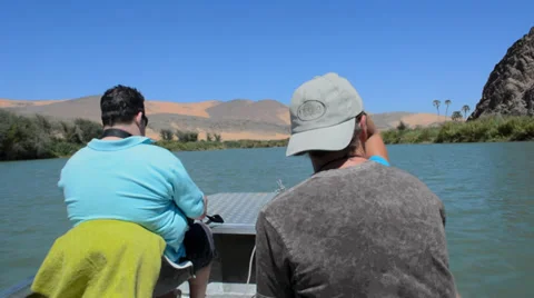 Namibia Namibia three tourists riding boat on  Kunene River Serra Cafema Camp 動画素材 37213321
