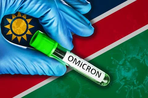Namibia outbreak of omicron variant. Hand holds a test tube with covid-19 virus Stock Photos
