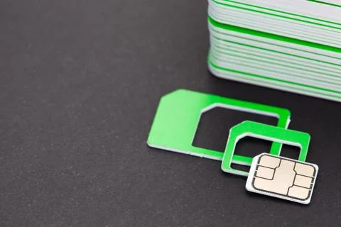 Nano sim card extract from sim card adaptor on dark background Stock Photos