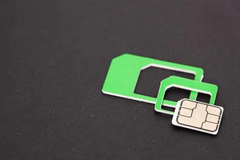 Nano sim card extract from sim card adaptor on dark background Stock Photos