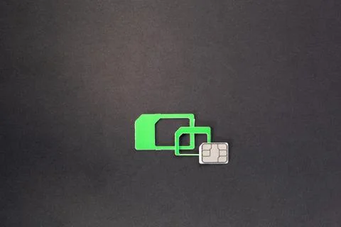 Nano sim card extract from sim card adaptor on dark background Stock Photos
