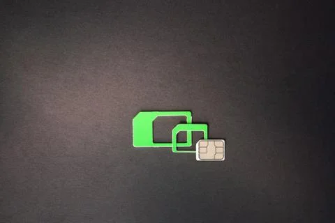 Nano sim card extract from sim card adaptor on dark background Stock Photos
