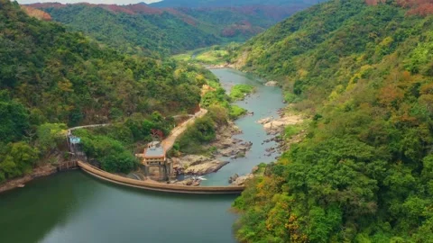 Nanta flying down the valley across dam day drone b-roll Stock Footage 169620705