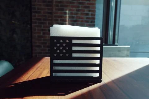 Napkin holder in a cafe on a table in the form of an American flag Stock Photos