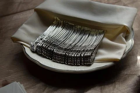 Napkins and silverware set up for a wedding. Stock Photos