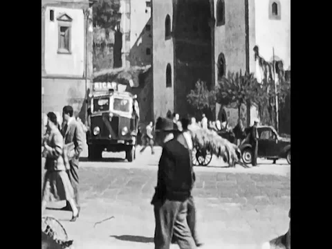 Naples, Italy, 1955 - People, cars and carts pass near Castel Capuano Stock Footage