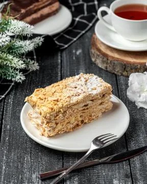 Napoleon cake with black tea on the table Stock Photos