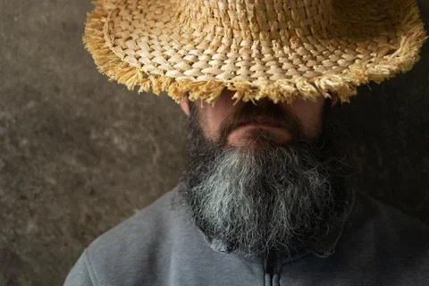 A napping man with a long beard in a hat Stock Photos