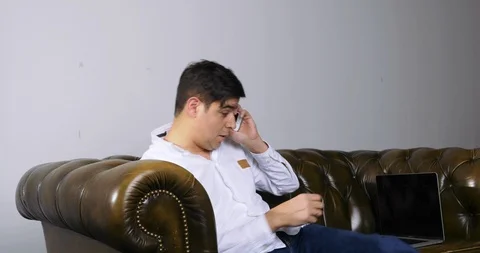 Napping Man Woken Up by Phone Call Begins Working on Laptop Stock Footage 120435564