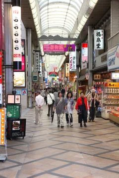 NARA, JAPAN - APRIL 26, 2012: Visitors shop at Higashi-muki covered street in Stock Photos