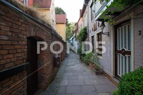 Narrow alley with small ancient stylish houses in Bremen quarter Schnoor Stock Photos