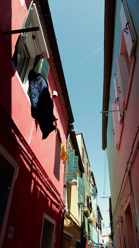 Narrow Burano lane between brightly painted houses Stock Footage 336712473