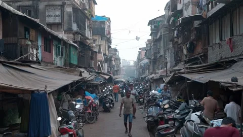Narrow congested lane with Indian people, dingy shops and old colonial buildings Stock Footage 328501461