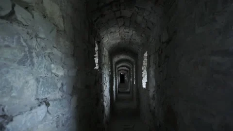 Narrow corridor in the old castle. The play of light and shadow Stock Footage 200749313