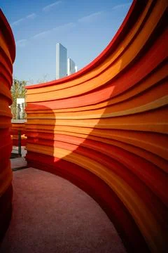 Narrow curved path between orange layered walls - Mystery concept Stock Photos