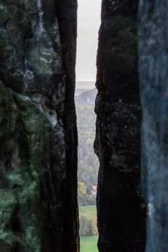 A narrow dark long gap between two stony cliffs Stock Photos