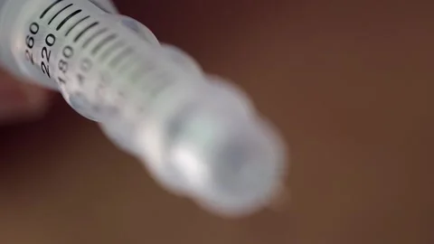 Narrow depth of field: Pull focus along barrel of injection pen needle Stock Footage 319835889