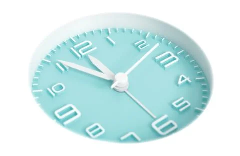 Narrow focus to clock with time 5 to 12 or 11.55 AM PM, turquoise clock face, Stock Photos