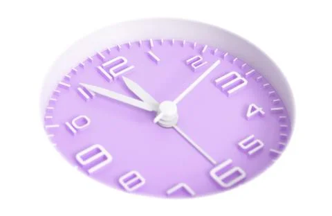 Narrow focus to clock with time 5 to 12 or 11.55 AM PM, violet clock face, on Stock Photos