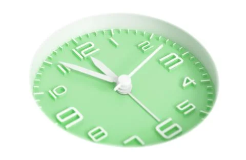 Narrow focus to clock with time 5 to 12 or 11.55 AM PM, green clock face, on  Stock Photos