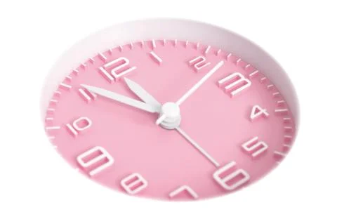 Narrow focus to clock with time 5 to 12 or 11.55 AM PM, pink clock face, on w Stock Photos