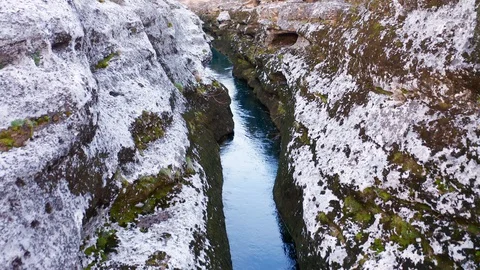 Narrow mountain river flowing through desolate rocky landscape Stock Footage 127799275