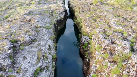Narrow mountain river flowing through rocky landscape Stock Footage 133160159