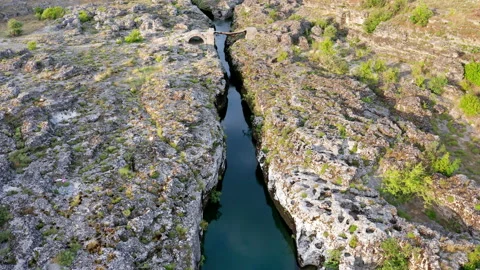 Narrow mountain river flowing through rocky landscape Stock Footage 133195598
